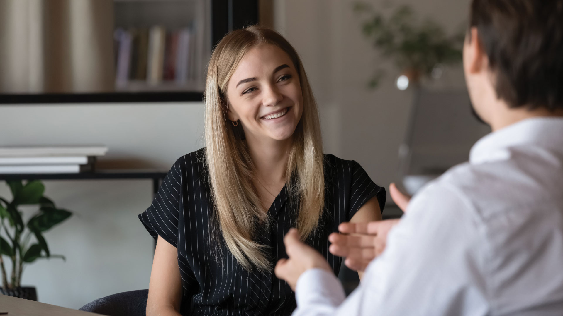 Young women talking with a man