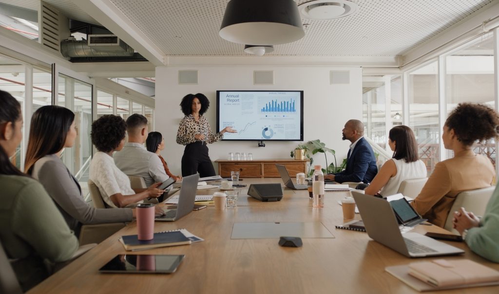 Strategyusiness people, meeting and presentation on screen for data analytics, statistics and financial growth in boardroom. Professional leader, woman or analyst with monitor for graphs, charts and report